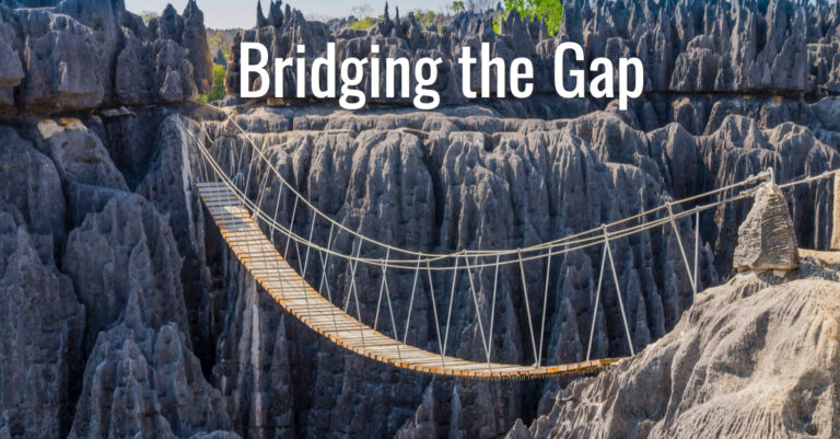 Rope bridge crossing chasm between stone cliffs